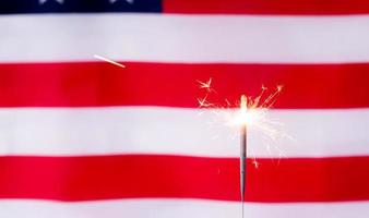 Shining sparkler over USA flag background photo