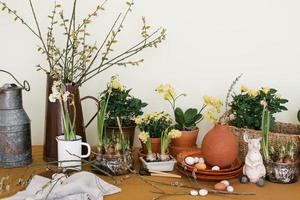 Serving of the Easter holiday table with primroses, eggs and rabbits in natural color photo