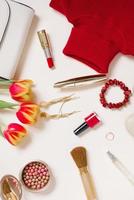 Stylish trending flat lay blogger for Valentine's Day. Red sweater, earrings, purse, bracelet, ring, lipstick, shoes and cosmetics. Top view photo