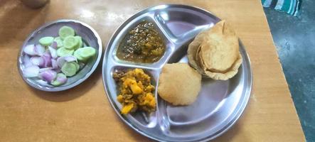 Indian Food Puri Sabzi Salad on a Table in Steel Plate photo