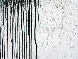 Abstract textured background with black paint smudges on a wall photo