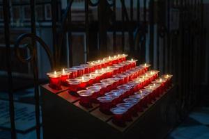 Candles on a stand inside a catholic church photo