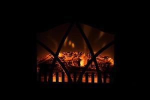 winter black background with fireplace and red hot blazing fire photo