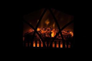 winter black background with fireplace and red hot blazing fire photo