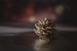 golden christmas cone on the background of bokeh in closeup photo