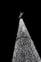 glowing christmas tree decoration on black background photo