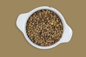 Lentils in bowl isolated with background. Top view. Flat lay. photo