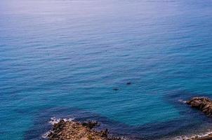 blue sea background with red kayaks flowing photo