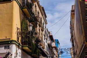 original historic building with balconies and potted plants in Alicante Spain photo