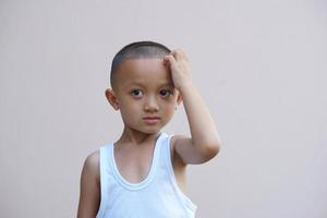 Asian boy having itchy face photo