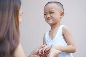 boy holding hands with mother happy smile photo