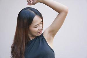 Asian woman smells of damp underarms photo