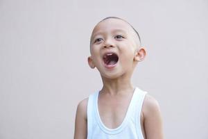 Asian boy smiling happily room wall background photo