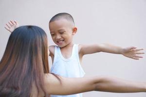 boy happily hugging his mother photo