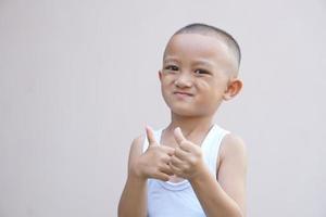 boy making a great symbol hand photo