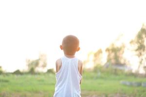 a boy watching the sunset happily photo