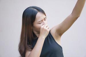 Asian woman smells of damp underarms photo