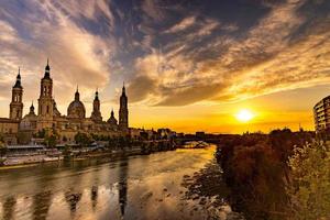 picturesque sunset on a summer day in the city of Zaragoza in Spain overlooking the river and the cathedral photo