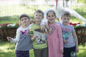 Group of preschoolers children on the street. Children from kindergarten for a walk. photo