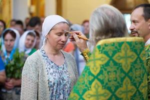 Palm Sunday.Orthodox anointing oil. Believers in the church. photo