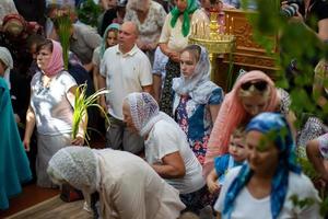 Many people in the temple celebrate Palm Sunday. Orthodox believers. A crowd of residents in the church. photo