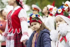 Slavic girl in national costume. Procession of Slavic people in national costumes. photo