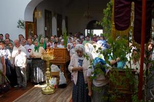 Many people in the temple celebrate Palm Sunday. Orthodox believers. A crowd of residents in the church. photo