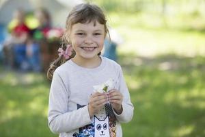 Funny six year old girl in the summer. Portrait of a preschool girl. photo