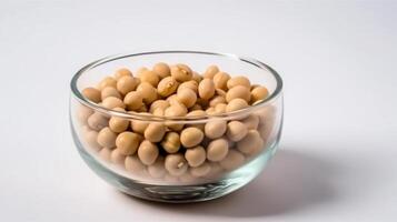 A glass bowl of soya beans or soybean isolated on white. photo