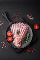 Delicious fresh pancetta with salt and spices cut into thin slices photo