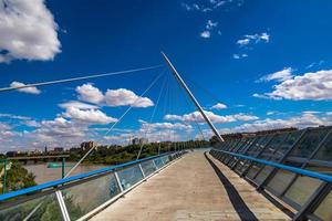 pedestrian suspension bridge over the Ebro river in Zaragoza, Spain on a summer day photo