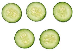 Sliced fresh cucumber on a white background, top view photo