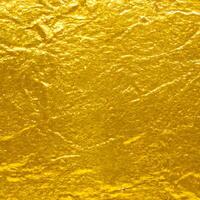 gold texture background. close up of shiny surface of gold. golden smooth material. gold leaf. . photo