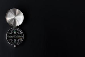 A photo of a compass on isolated black background, after some edits.