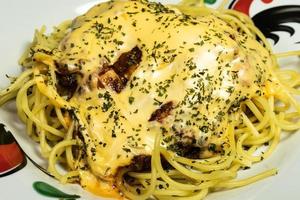 A photo of spaghetti on a chicken patterned plate, after some edits.