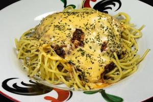A photo of spaghetti on a chicken patterned plate, after some edits.