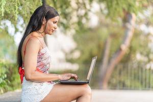 Profile of a transgender woman working in remote in park photo