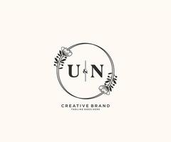 initial UN letters hand drawn feminine and floral botanical logo suitable for spa salon skin hair beauty boutique and cosmetic company. vector