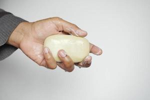 young man washing hands with soap warm water photo