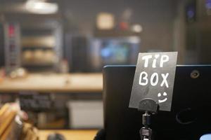 close up of a tips box in a cafe photo