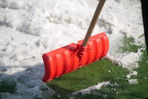men using Red blurry snow shovel. photo