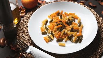 Pasta on a white plate on a dark background. photo