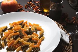 Pasta on a white plate on a dark background. photo