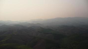 Aerial view of mountains covered in haze from burning forests. Areas with dense smog and covered with PM2.5. Air pollution and ecological problems. video