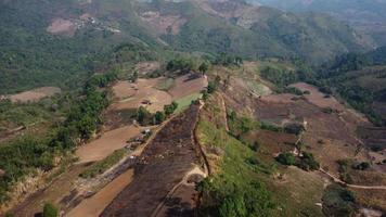 Mountain destroyed by human for cultivate plants. Aerial view of mountains covered in haze from burning forests. Areas with dense smog and covered with PM2.5. Air pollution and ecological problems video