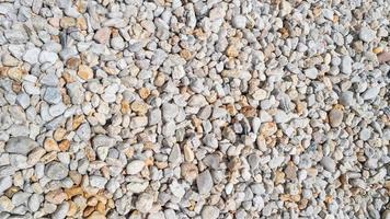 Panoramic view over a gravel, river beach pebble, stony background with patterns, closeup, details. photo