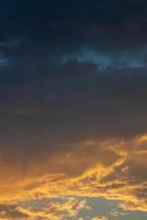 Cover page with gradient soft deep orange sky, illuminated clouds at bloody sunset as a background. photo