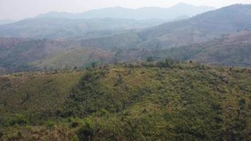 aéreo ver de montañas cubierto en calina desde ardiente bosques areas con denso niebla tóxica y cubierto con pm2.5. aire contaminación y ecológico problemas. video