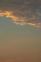 Cover page with gradient soft deep orange sky, illuminated clouds at bloody sunset as a background. photo