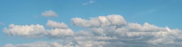 Banner with panoramic view over deep blue clean sky with illuminated clouds as a background. photo